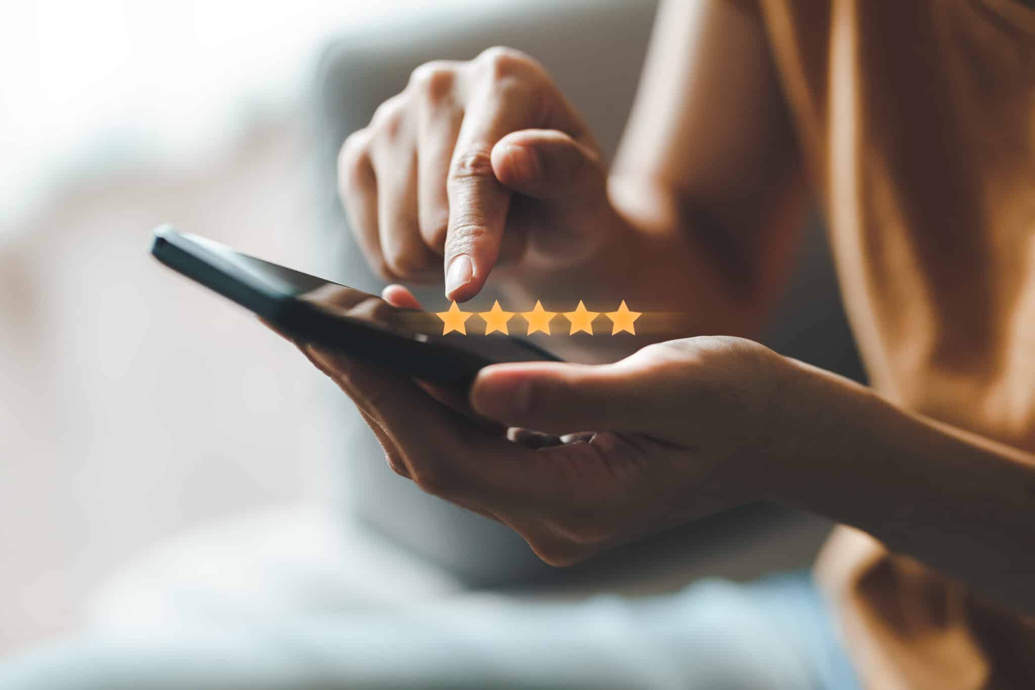 Close up of woman customer giving a five star rating on smartpho review management Kenosha, avoid negative reviews Kenosha, customer review tool Kenosha